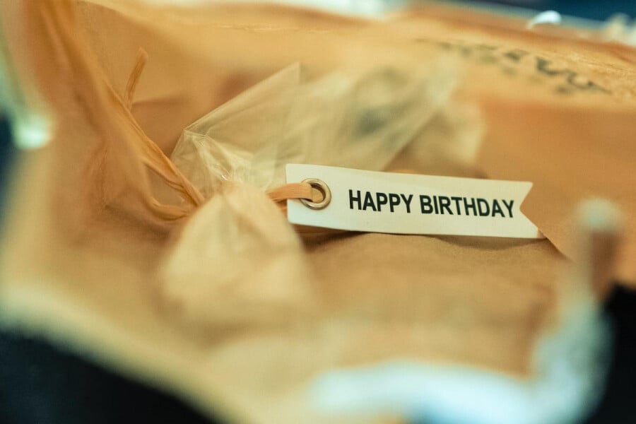 Happy birthday message attached to top of gift