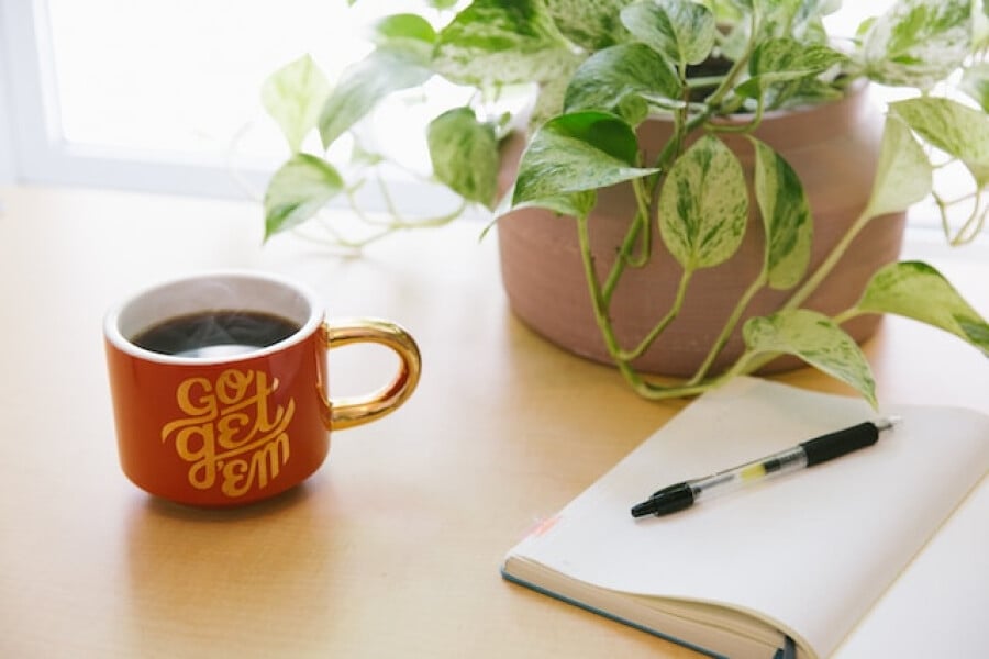 a posh coffee cup and notebook