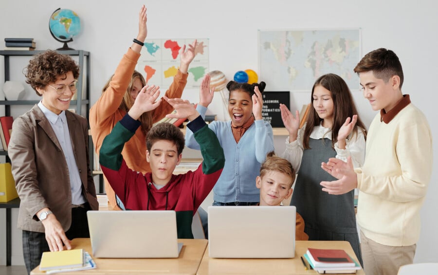 Children Clapping Together in a Classroom
