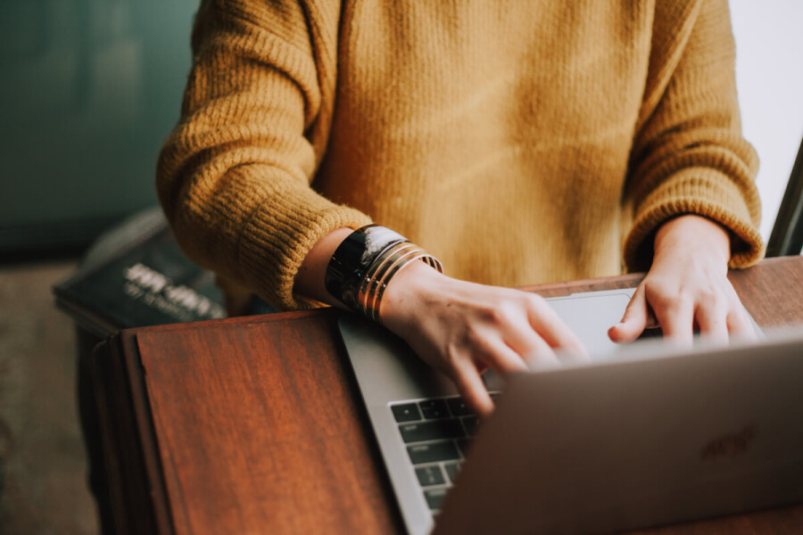 working from home typing on laptop keyboard