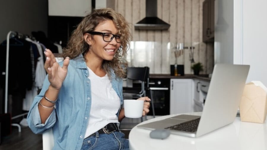 Positive woman working from home