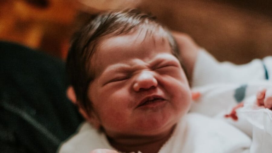 Newborn baby being held