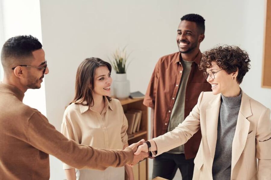 Shaking the hands of a co-worker leaving for a new job