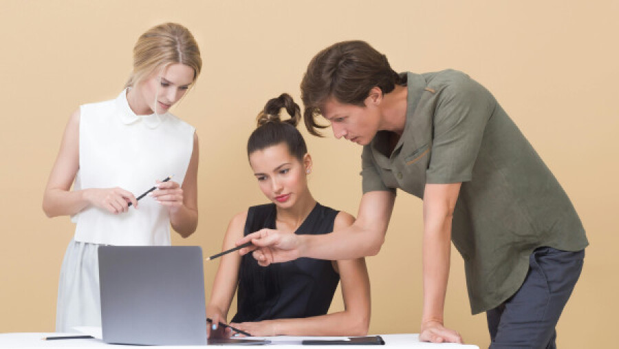 Colleagues looking at a laptop screen