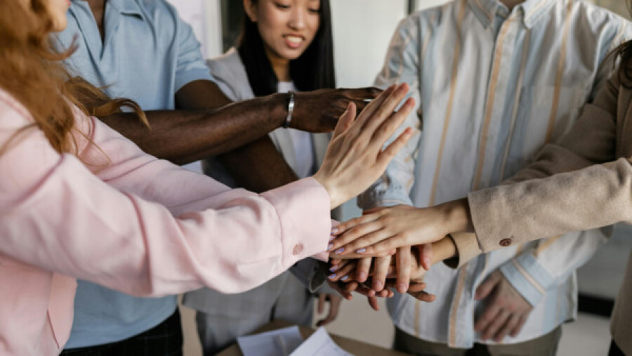 Colleagues stacking their hands on top of each other