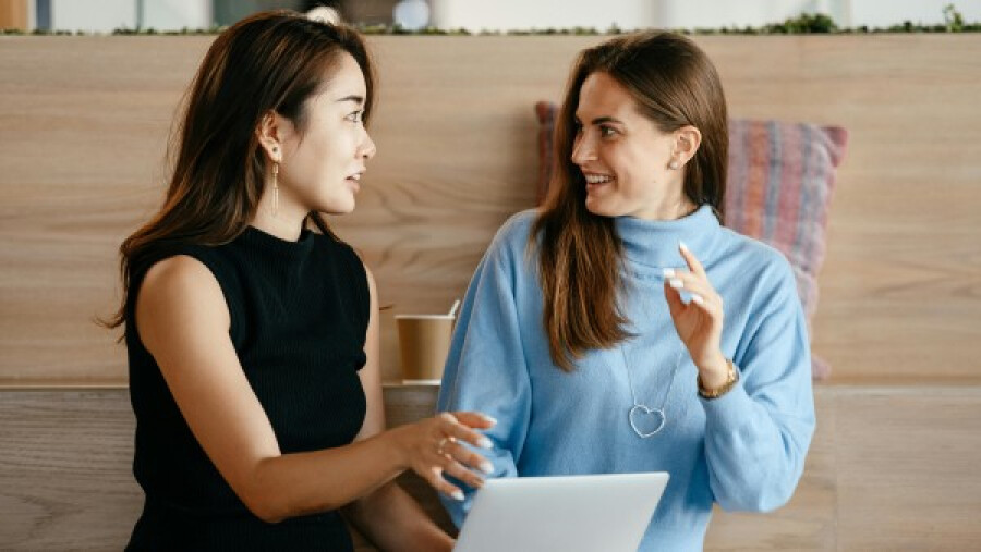 Two women talking and smiling to each other