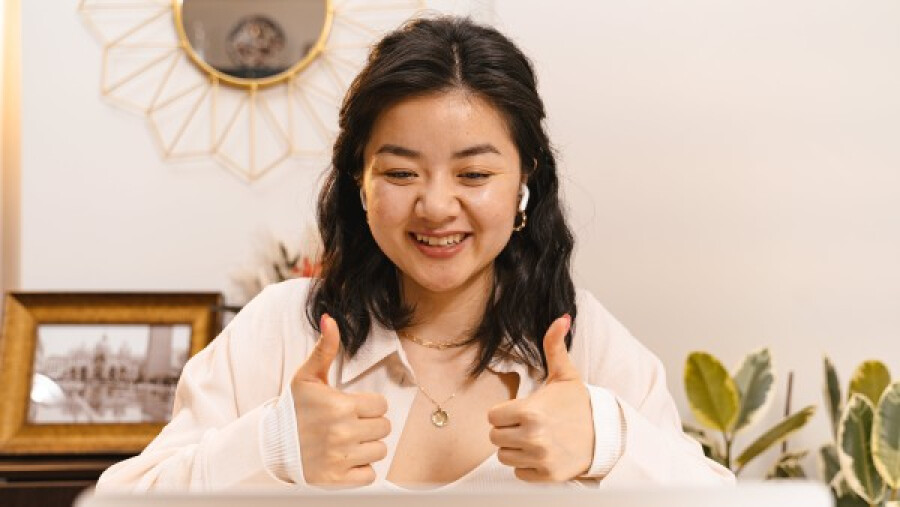 Woman in a video call doing a thumbs up