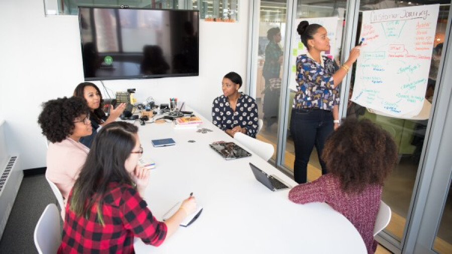 Female colleagues gathered inside a conference room