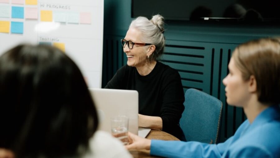 Elderly woman discussing a project with the team