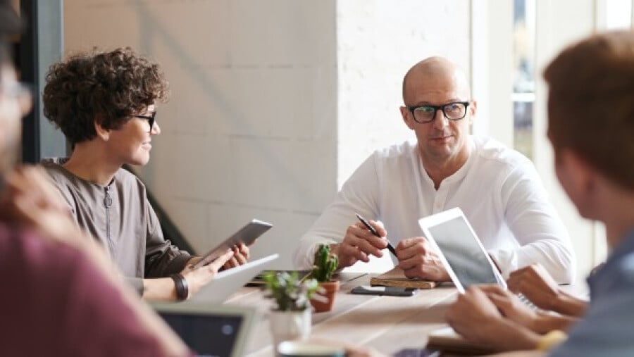 Colleagues sitting at a table and listening to each other