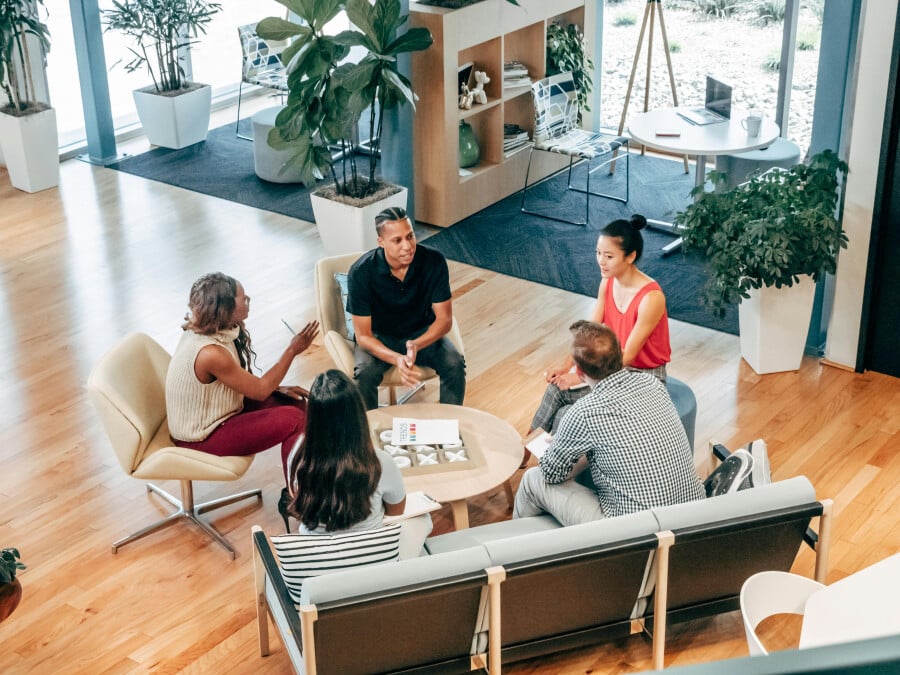 People Sitting on Chairs Around a Table