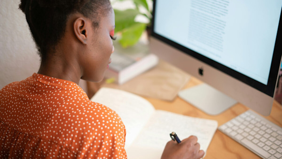 Woman Writing on Her Notebook