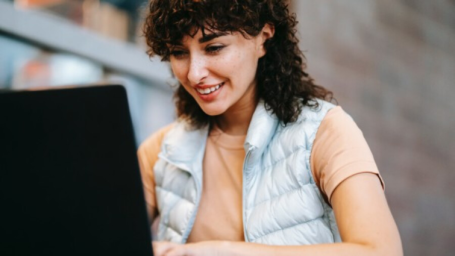 Woman working on a laptop at a table