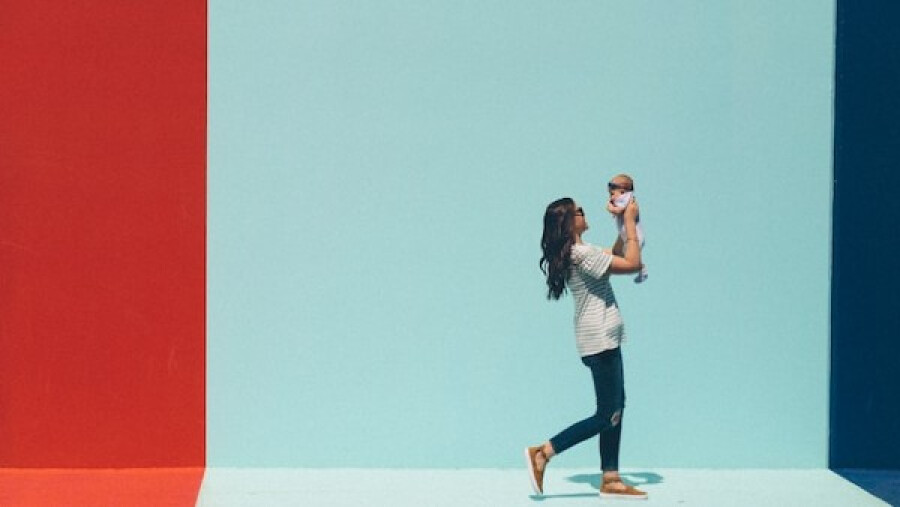 woman carrying baby while walking
