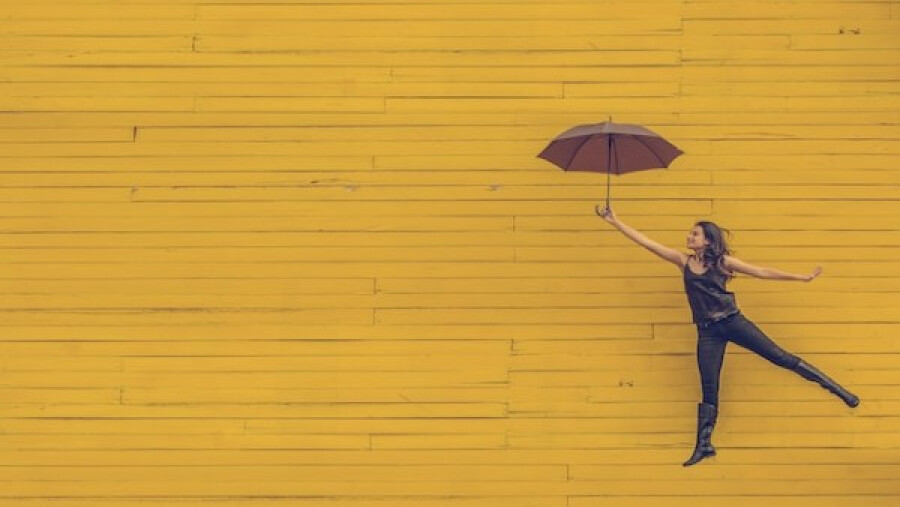 woman holding brown umbrella