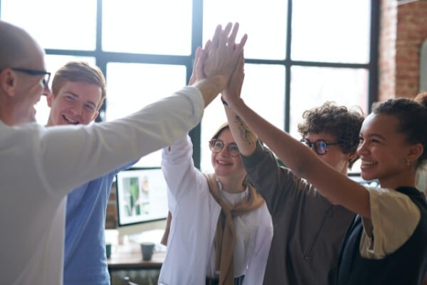 An image showing a team high fiving