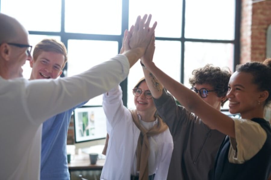 An image showing a team high fiving